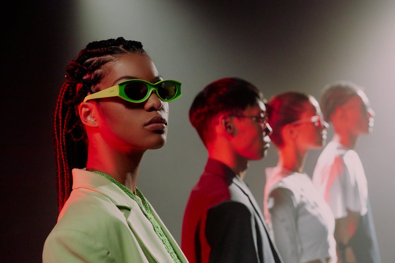 hero-about Youthful group posing in stylish attire with neon lighting, emphasizing modern fashion trends.